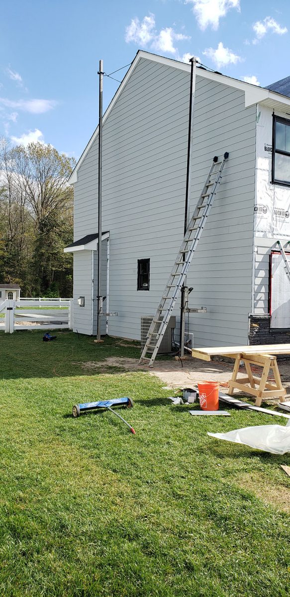 Siding installation on a home in Delaware by L&L Services.