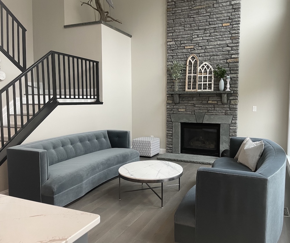 remodeled living room with a monochrome grey color to match the furniture and fireplace