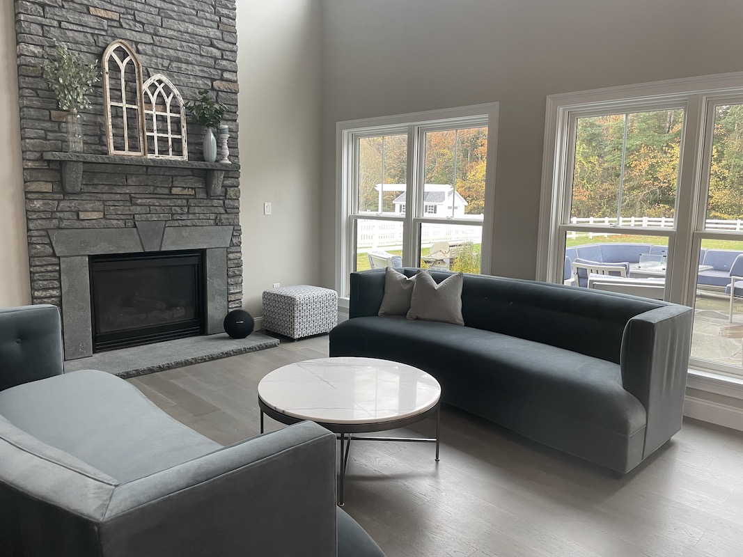 remodeled living room with a monochrome grey color to match the furniture and fireplace