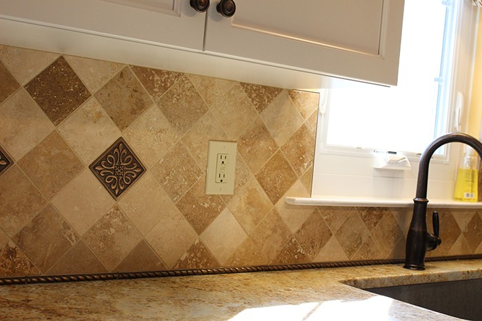 douglassville kitchen remodel close up of yellow diamond backsplash and outlet by sink