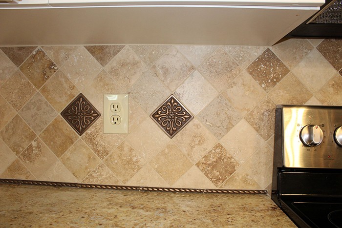 douglassville kitchen remodel close up of yellow diamond backsplash and outlet near the stove