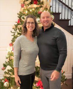 rick with michele posing with a christmas tree, rick the repair specialists