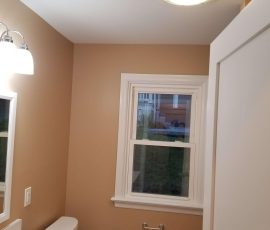 overhead light and refinished windows in a bathroom