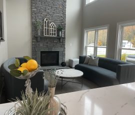 remodeled living room with a monochrome grey color to match the furniture and fireplace