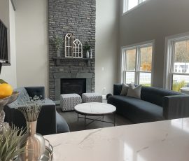 remodeled living room with a monochrome grey color to match the furniture and fireplace