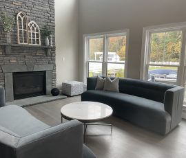 remodeled living room with a monochrome grey color to match the furniture and fireplace