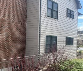 brick wall and siding of house
