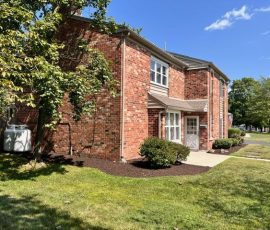 house with wrap around mulched garden